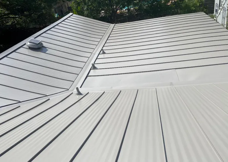 Solar attic fan installed on a metal roof for Roof Ventilation in Prospect Park